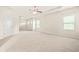 Spacious bedroom has neutral carpet, recessed lighting and tray ceiling with ceiling fan at 15 Manas Ct, Covington, GA 30016