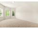 Bright bedroom with large windows providing ample natural light and neutral carpet at 15 Manas Ct, Covington, GA 30016