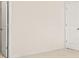 Bright bedroom with neutral carpet, white walls, and two white doors at 15 Manas Ct, Covington, GA 30016
