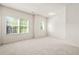 Bedroom features large windows, neutral carpet, and a light and airy atmosphere at 15 Manas Ct, Covington, GA 30016
