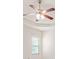 A bedroom ceiling fan is set against a tray ceiling and has a window with blinds at 15 Manas Ct, Covington, GA 30016