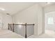 Upstairs hallway showcasing modern black metal and wooden railing at 15 Manas Ct, Covington, GA 30016