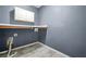 Small laundry area with gray tile flooring at 15 Manas Ct, Covington, GA 30016