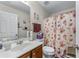 Clean bathroom with vanity, mirror, and floral shower curtain at 2034 Reavis Blf, Conyers, GA 30012