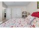 Comfortable bedroom featuring floral bedding and ample closet space at 2034 Reavis Blf, Conyers, GA 30012