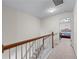 Upstairs hallway with carpet, wood railing, and doorway to a bedroom at 2034 Reavis Blf, Conyers, GA 30012