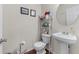 Cozy powder room with pedestal sink and decorative accents at 2034 Reavis Blf, Conyers, GA 30012
