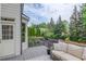 Inviting back deck features a cozy sofa and a scenic view of the private backyard at 2112 Ivey Chase Dr, Dacula, GA 30019