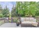 Relaxing back deck with comfortable seating and a tranquil view of the wooded backyard at 2112 Ivey Chase Dr, Dacula, GA 30019