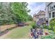 Spacious backyard featuring a fire pit area, lush green lawn, and mature trees and landscaping at 2112 Ivey Chase Dr, Dacula, GA 30019