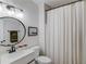 Clean bathroom with a single sink vanity, a framed mirror, and a shower with a white curtain at 2112 Ivey Chase Dr, Dacula, GA 30019