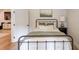 Cozy bedroom with a black metal bed frame, soft linens, and soothing decor at 2112 Ivey Chase Dr, Dacula, GA 30019