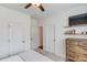 Neutral bedroom with ample storage, a ceiling fan, and a TV mounted on the wall at 2112 Ivey Chase Dr, Dacula, GA 30019