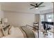 Serene bedroom featuring a metal bed frame, desk, and natural light from large windows at 2112 Ivey Chase Dr, Dacula, GA 30019