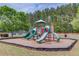 Community playground surrounded by wood chips with several colorful slides and climbing apparatus at 2112 Ivey Chase Dr, Dacula, GA 30019