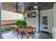 Inviting covered deck with a large dining table, mounted TV, and access to the home's interior at 2112 Ivey Chase Dr, Dacula, GA 30019
