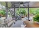 Relaxing covered deck featuring a swing bench, outdoor dining, fan and backyard view at 2112 Ivey Chase Dr, Dacula, GA 30019