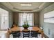 Dining room with a wooden table, stylish chairs, pendant lighting, and wainscoting at 2112 Ivey Chase Dr, Dacula, GA 30019