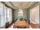 Dining room with hardwood floors, modern light fixture, and view of the front yard at 2112 Ivey Chase Dr, Dacula, GA 30019