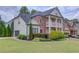 Charming two-story traditional-style home with a brick facade, white accents and manicured lawn at 2112 Ivey Chase Dr, Dacula, GA 30019