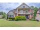 Charming two-story brick home with a covered porch and manicured lawn at 2112 Ivey Chase Dr, Dacula, GA 30019