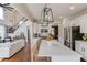 Bright kitchen featuring a large island with seating, stainless steel appliances, and elegant pendant lighting at 2112 Ivey Chase Dr, Dacula, GA 30019