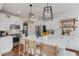 Well-lit kitchen with white cabinetry, quartz countertops, and a stainless steel refrigerator at 2112 Ivey Chase Dr, Dacula, GA 30019
