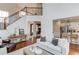Open living space with a hardwood floors, staircase, and view to the kitchen at 2112 Ivey Chase Dr, Dacula, GA 30019