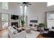 Spacious living room with fireplace, large windows, hardwood floors and high ceilings at 2112 Ivey Chase Dr, Dacula, GA 30019