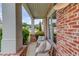 Cozy covered porch with brick accents and comfortable seating, perfect for relaxing outdoors at 2112 Ivey Chase Dr, Dacula, GA 30019