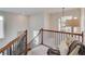 Elegant staircase with wooden railings, iron spindles, and a seating area on the landing at 2112 Ivey Chase Dr, Dacula, GA 30019