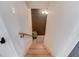 A stairway with wooden stairs and a wooden handrail going down to a dark brown finished area at 2112 Ivey Chase Dr, Dacula, GA 30019