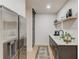 This wet bar features a stainless steel refrigerator, a dark brown cabinet and a white counter top at 2112 Ivey Chase Dr, Dacula, GA 30019
