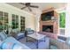 Covered porch featuring a brick fireplace, ceiling fan, and comfortable seating, perfect for enjoying the outdoors at 101 Morgan Ln, Canton, GA 30115