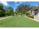 Expansive backyard with lush lawn and a serene pergola-covered seating area, perfect for relaxation at 101 Morgan Ln, Canton, GA 30115