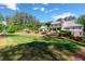 Sprawling backyard featuring a large lawn, pergola, and well-maintained landscaping at 101 Morgan Ln, Canton, GA 30115