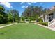 Expansive backyard featuring lush lawn, manicured landscaping, and a pergola-covered lounge area at 101 Morgan Ln, Canton, GA 30115