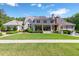 Expansive backyard with lush lawn, covered porch, and manicured hedges at 101 Morgan Ln, Canton, GA 30115