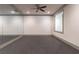 Basement gym with mirrored wall and ceiling fan perfect for working out at home at 101 Morgan Ln, Canton, GA 30115