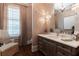 Bathroom features wood accents, stylish wallpaper, and natural light at 101 Morgan Ln, Canton, GA 30115