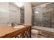Bathroom with glass-enclosed tub and stylish wood-look tile at 101 Morgan Ln, Canton, GA 30115