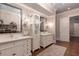Luxurious bathroom boasts dual vanities, decorative mirrors, and hardwood floors at 101 Morgan Ln, Canton, GA 30115