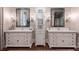Bright bathroom showcasing dual vanities with granite countertops, decorative mirrors, and built-in storage at 101 Morgan Ln, Canton, GA 30115