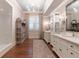Bathroom featuring double sink vanity, hardwood floors, sconces, and a freestanding glass shower at 101 Morgan Ln, Canton, GA 30115