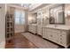 Bright bathroom with hardwood floors, double vanity, custom mirrors, and natural light at 101 Morgan Ln, Canton, GA 30115