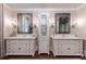 Elegant bathroom featuring double vanities, decorative mirrors, and a central storage cabinet at 101 Morgan Ln, Canton, GA 30115