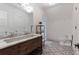 Bright bathroom with a double vanity, patterned tile floor, and a glass enclosed shower at 101 Morgan Ln, Canton, GA 30115