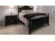 Bedroom with black furniture including a four-poster bed and nightstand with lamps at 101 Morgan Ln, Canton, GA 30115