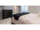 Bedroom showcasing a bed with a dark throw blanket and a wooden dresser against gray walls at 101 Morgan Ln, Canton, GA 30115
