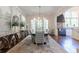 Elegant dining room with a large table, wainscoting, and kitchen access, ideal for Gathering meals and entertaining at 101 Morgan Ln, Canton, GA 30115